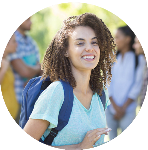 Our Mission Girl smiling with a backpack on